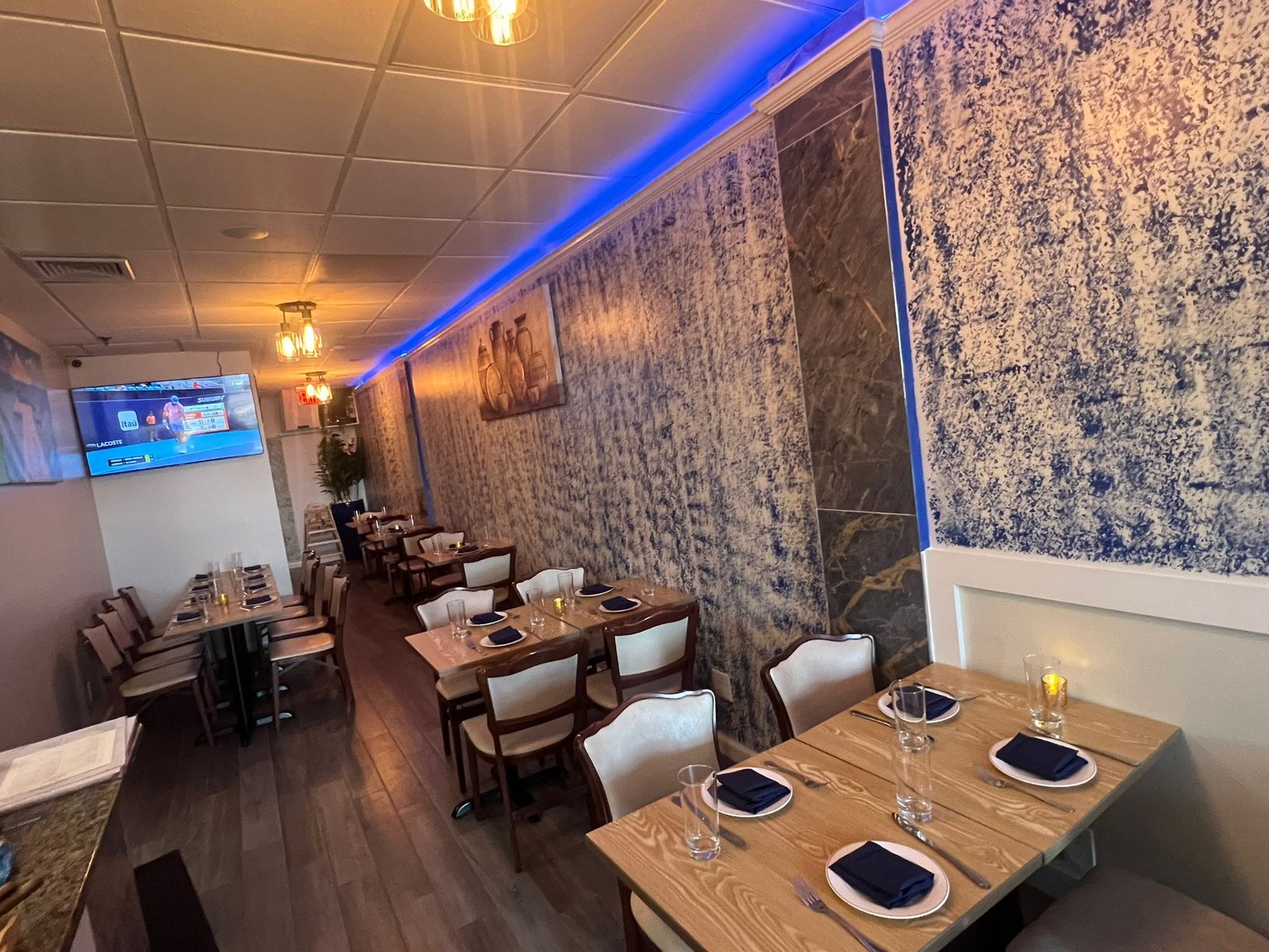 The original, smaller Blue Waters dining room with its blue-lit wall