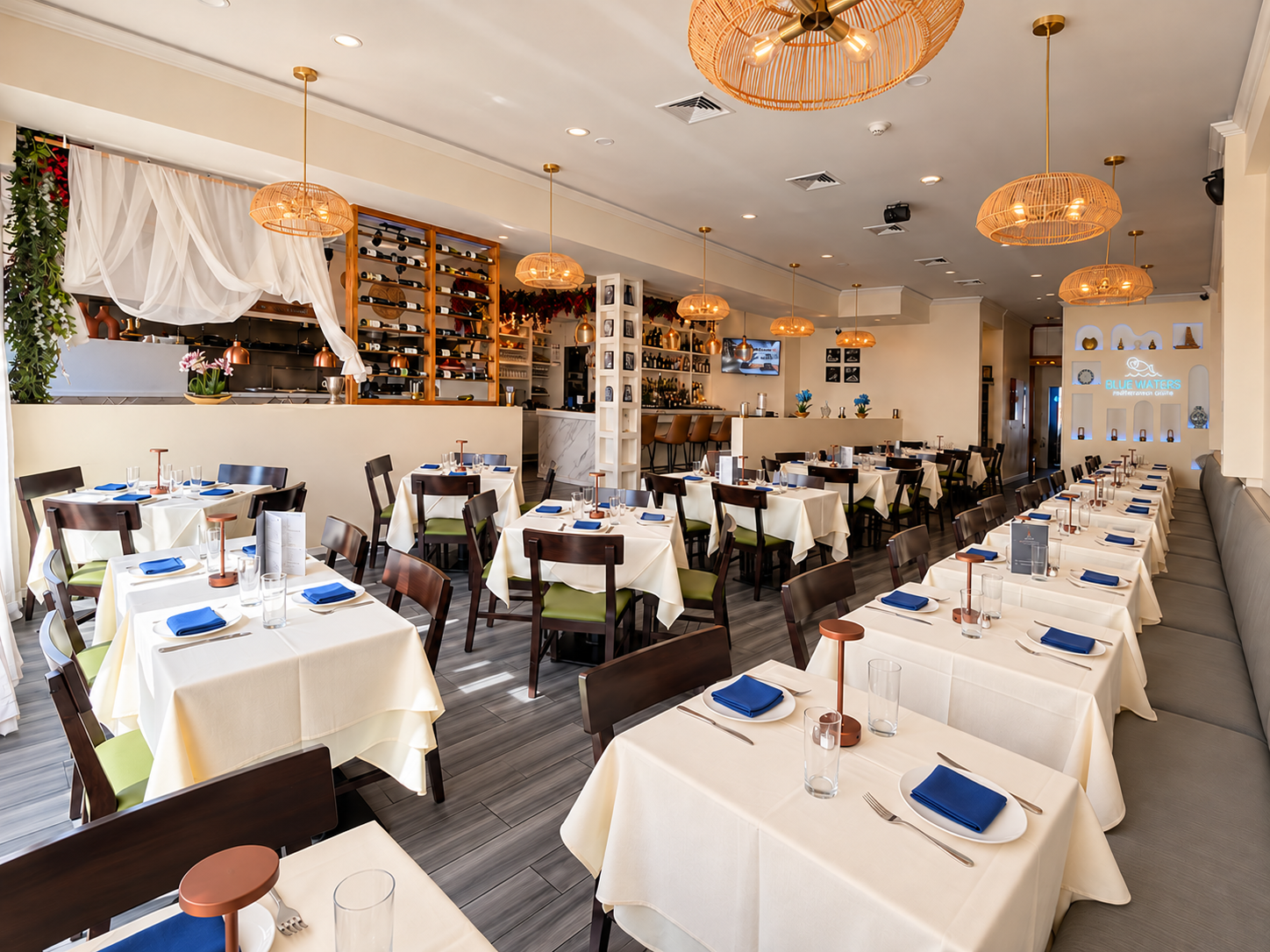 Blue Waters dining room today, with white tablecloths and woven pendant lights